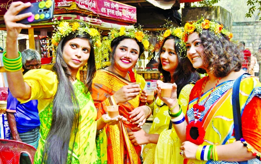 Young girls pose for a selfie while celebrating Pahela Falgun and Valentine's Day on DU campus on Sunday.