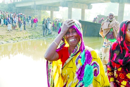 A woman wails as her relative dies in a tragic accident under Damri Bridge on Sylhet-Tamabil road on Sunday. The bus fell into a river under a bridge.