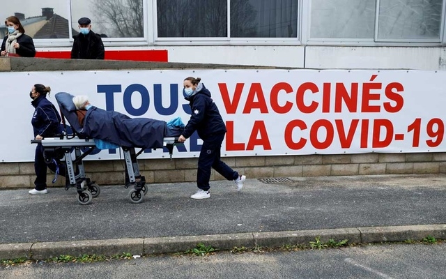 A woman is carried on a stretcher to the COVID-19 vaccination centre during a visit by French Health Minister Olivier Veran at the South Ile-de-France Hospital Group, in Melun, on the outskirts of Paris, France February 8, 2021.