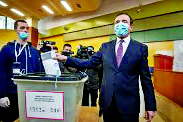 Albin Kurti, right, a candidate for prime minister of Vetevendosje (Self-Determination), casts his ballot paper in parliamentary elections in capital Pristina, Kosovo.