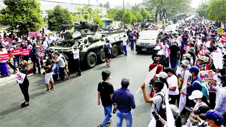 Protesters lined the streets where armoured vehicles were deployed near the Central Bank in Yangon on Monday.