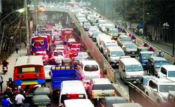 Vehicles remain stuck in tailbacks on the Moghbazar-Mouchak flyover near the capital's Tejgaon at around 5:30pm on Monday.