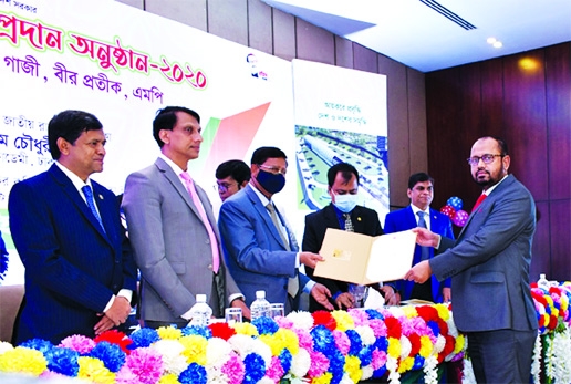 S M Anisuzzaman, CEO of Bangladesh Infrastructure Finance Fund Limited (BIFFL) receiving the '3rd Highest Taxpayer for 2019-2020' card in the category of Non-Bank Financial Institution from Textile and Jute Minister Golam Dastagir Gazi (Birpatik), MP, a