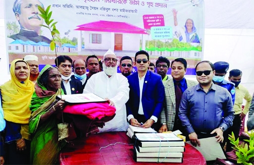 Syed Nazibul Bashar Maizvandary, MP Chittagong-2, hands over documents of houses among the landless families in Fatikchhari of Chattogram district at a ceremony on Monday.