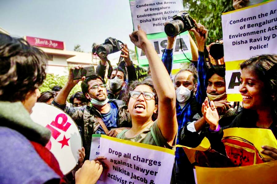 Demonstrators shout slogans during a protest against the arrest of 22-year-old climate activist Disha Ravi, outside the police headquarters in New Delhi, India on Tuesday.
