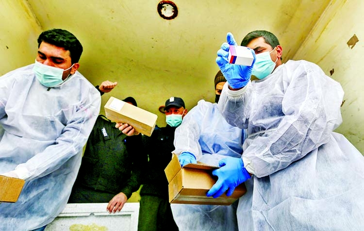 Palestinian workers unload the first shipment of Covid-19 vaccines, in the southern Gaza Strip February on Wednesday.