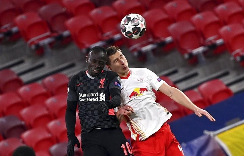 Liverpool's Sadio Mane (left) and RB Leipzig's Willi Orban battle for a header during the Champions League round of 16, first leg, soccer match at the Puskas Ferenc Arena in Budapest, Hungary on Tuesday.