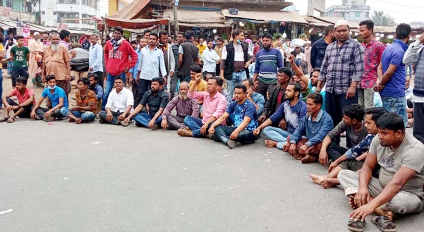 Bus employees stage a sit-in at Ruptali Bus Terminal on Saturday demanding release of two employees who were arrested in attack on students of Barishal University.