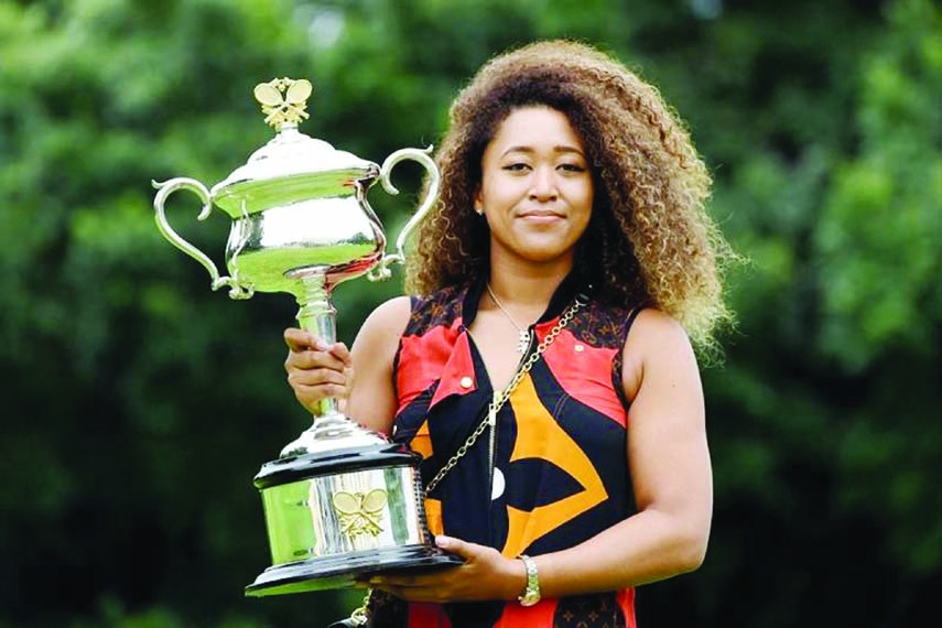 Japan's Naomi Osaka poses with the 2021 Australian Open winner's trophy at the Government House in Melbourne on Sunday, following her victory over Jennifer Brady of the US in the women's singles final of the tennis tournament.