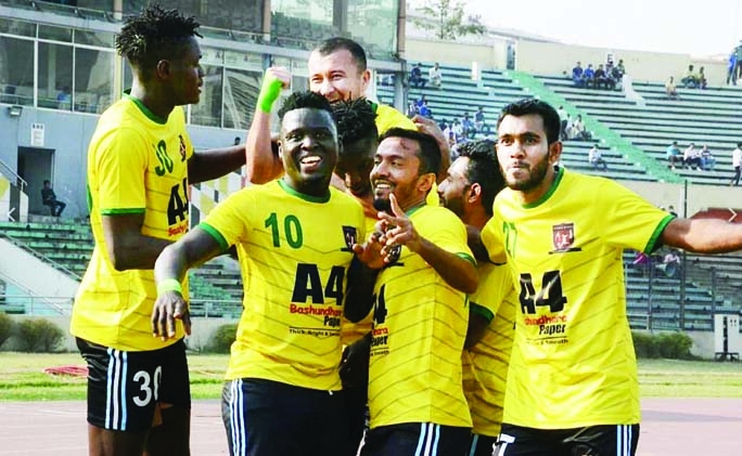Players of Lieutenant Sheikh Jamal Dhanmondi Club celebrating after scoring a goal against Bangladesh Police Football Club in their match of the Bangladesh Premier League Football at the Bangabandhu National Stadium (BNS) on Monday.
