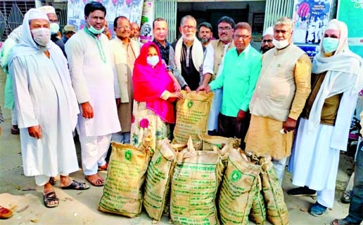 Sirajul Islam Khan Raju, Chairman of Adamdighi Upazila in Bogra district, distributes dry foods among the poor and helpless people as a gift from Prime Minister at a ceremony on upazila parishad premises on Wednesday.
