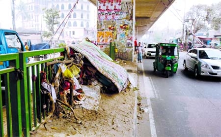 Illegal shops, slum-like make shift houses have been set up beneath the Moghbazar Flyover in the capital which cause adverse effect on the environment. This photo was taken on Wednesday.