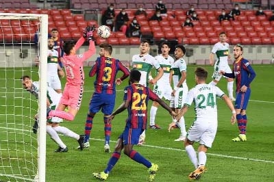 Elche's Spanish goalkeeper Edgar Badia (left) blocks a shot on goal during the Spanish league football match between FC Barcelona and Elche CF at the Camp Nou stadium in Barcelona on Wednesday.