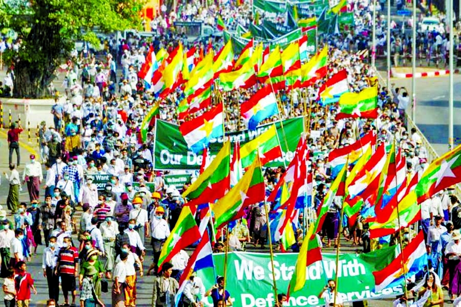 Supporters of Myanmar's military carry banners and flags during a rally in Yangon, Myanmar on Thursday.