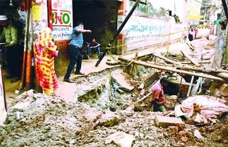 Pedestrians’ walkway has disappeared as the road has been excavated for development works by construction firms at Moghbazar area in the capital on Thursday.