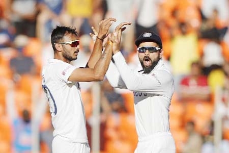 Axar Patel (left) celebrates a wicket with an excited Virat Kohli on the second day of the Third Test between India and England at Ahmedabad in India on Thursday.