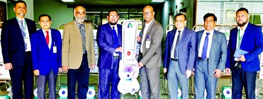 Md. Mustafa Khair, Additional Managing Director of First Security Islami Bank Ltd, handing over weight scale machines to Ziauddin Ahmed, Director Administration (Joint Secretary) of Biman Bangladesh Airlines Ltd to use at the airline's check-in counter a