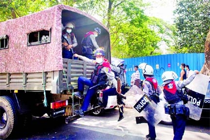 Riot police officers get on a police vehicle during a rally against the military coup in Yangon, Myanmar on Friday.