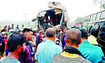 People crowd the spot of the smashed bus as two buses collided head-on leaving eight people dead at Rashidpur area in South Surma Upazila of Sylhet district on Friday.