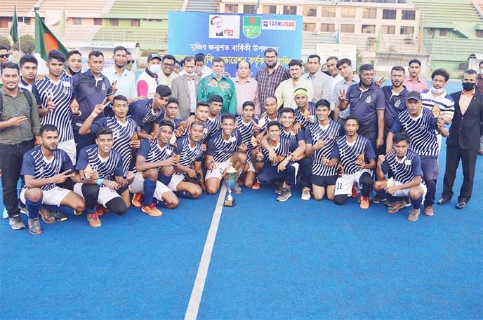 Members of Bangladesh Navy, the champions in the 'Mujib Borsho' Shaheed Smriti Hockey Competition with the chief guest President of Bangladesh Hockey Federation (BHF) and Air Chief Marshal Masihuzzaman Serniabat and the other officials of BHF pose for a