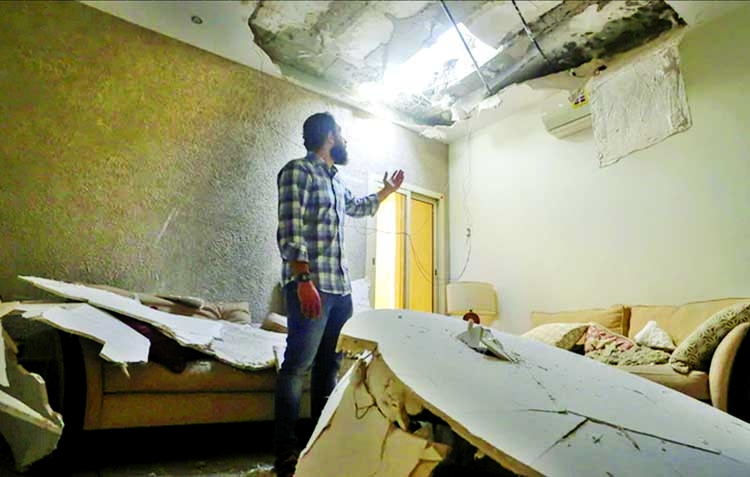 Mohamed Fahim inspects his house that was damaged by an intercepted missile in the aftermath of what Saudi-led coalition said was a thwarted Houthi missile attack, in Riyadh, Saudi Arabia, Feb. 27, 2021.