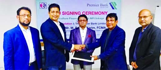 Rasel Ahmed Liton, CEO of SKS Foundation and Mohammed Emtiaz Uddin, Head of SME & Agriculture Banking of Premier Bank Limited, exchanging document after signing a MoU at the bank's head office in the city recently. Under the deal, the bank will provide A