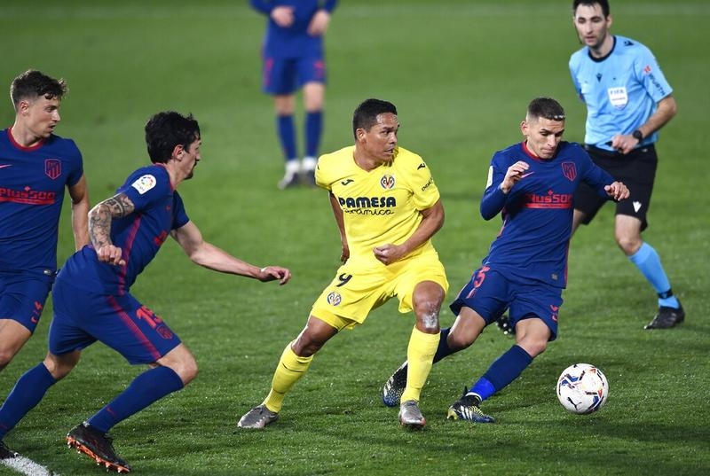 Atletico Madrid's Lucas Torreira (right) is challenged by Villareal's Carlos Bacca during the Spanish La Liga soccer match between Villarreal and Atletico Madrid at the Ceramica stadium in Villarreal, Spain on Sunday.
