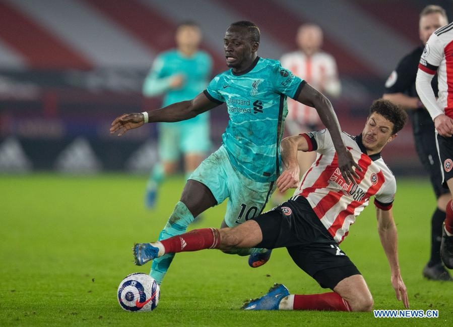 Liverpool's Ozan Kabak (right) vies with Sheffield United's Billy Sharp during the Premier League football match between Sheffield United FC and Liverpool FC in Sheffield, Britain on Sunday.