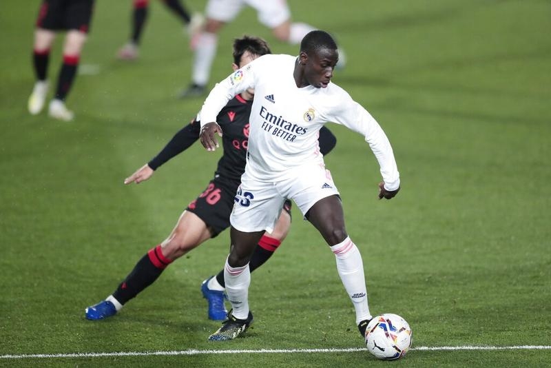 Real Madrid's Ferland Mendy (right) and Real Sociedad's Martin Zubimendi vie for the ball during the Spanish La Liga soccer match between Real Madrid and Real Sociedad at Alfredo di Stefano stadium in Madrid, Spain on Monday.