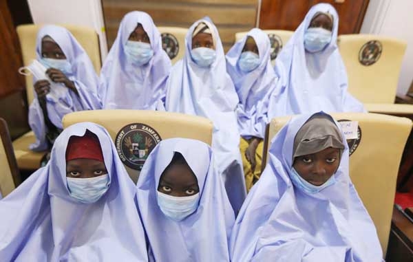 Girls who were kidnapped from a boarding school in the northwest Nigerian state of Zamfara, look on after their release in Zamfara, Nigeria on Tuesday.