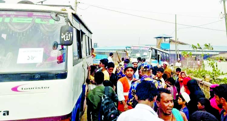 Rohingyas get into buses for Bhasan Char from Shamnapur Bharachora Rohingya camp in Teknaf on Tuesday.