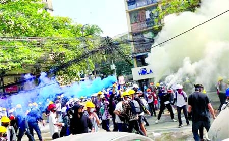 Protesters set off smoke grenades to block the view from snipers in Sanchaung, Myanmar on Wednesday.