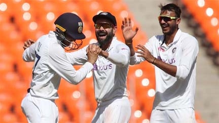 Indian captain Virat Kohli (center) celebrates with bowler Axar Patel (right) and player S Gill (left) after taking the wicket of England batsman Daniel William Lawrence on the first day of the fourth Test in Ahmedabad on Thursday.