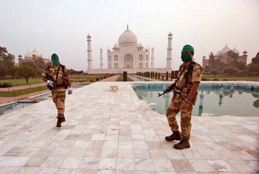 Security personnel wearing protective face masks stand guard in front of Taj Mahal after authorities reopened the monument to visitors, amidst the coronavirus disease (COVID-19) outbreak, in Agra on September 21, 2020.