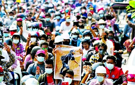 People attend the funeral of Angel a 19-year-old protester also known as Kyal Sin who was shot in the head as Myanmar forces opened fire to disperse an anti-coup demonstration in Mandalay.