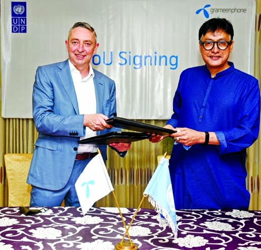 Jens Becker, acting CEO and CFO of Grameenphone (GP) and Sudipto Mukerjee, Resident Representative of UNDP Bangladesh, exchanging document after signing a MoU to collaborate on exploring avenues and potential program designs to accelerate the nation's fu