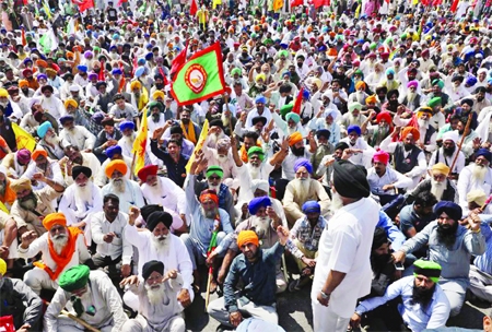 Farmers block an expressway to mark the 100th day of the protest against the farm laws, near Kundli border, in Haryana, India.