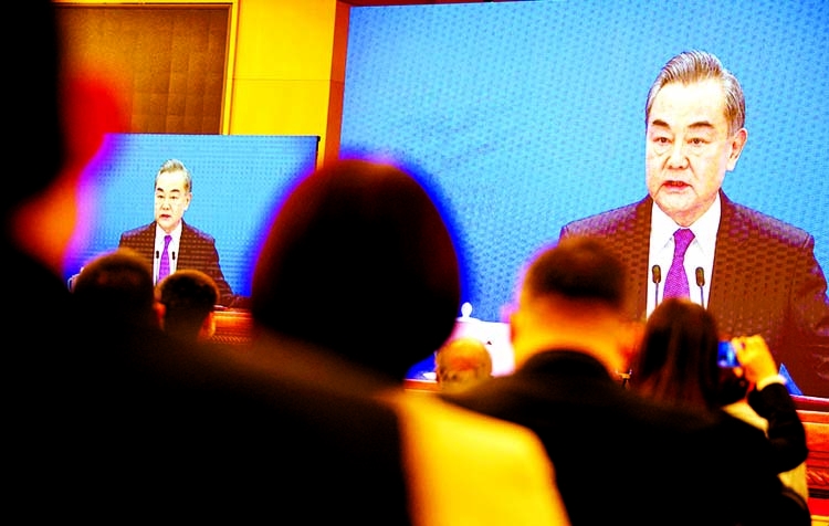 Chinese Foreign Minister Wang Yi speaks via live video transmission during a press conference at the National People's Congress in Beijing on Sunday.