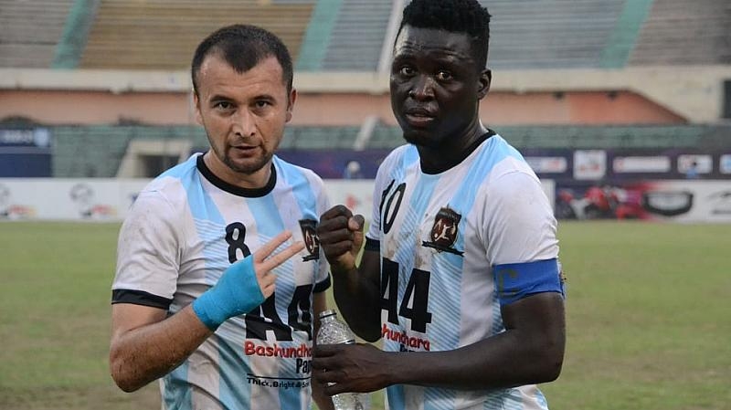 Sheikh Jamal Dhanmondi Club Limited's Uzbek recruit Otabek (left) and Gambian recruit Solomon King pose for a photo session after beating Dhaka Mohammedan Sporting Club in their match of the Bangladesh Premier League Football at the Bangabandhu National