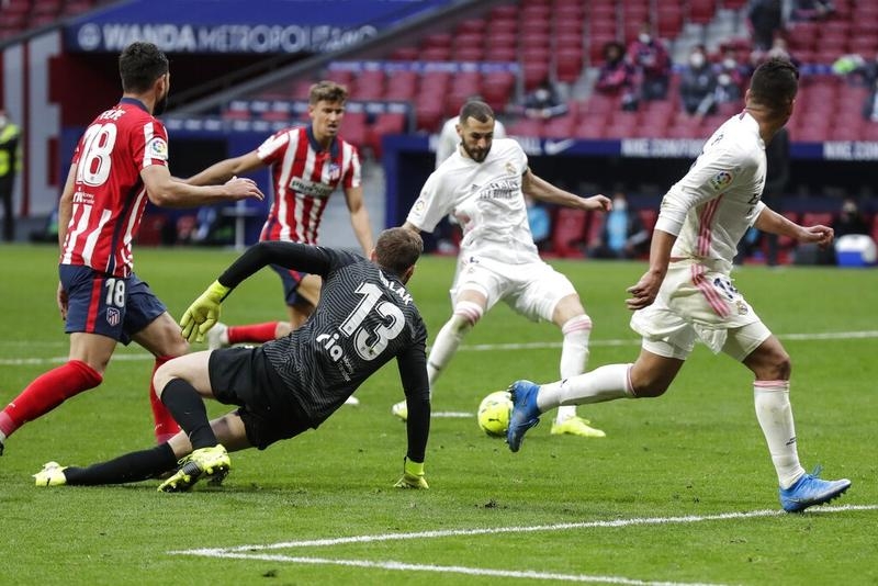 Real Madrid's Karim Benzema scores his side's opening goal during the Spanish La Liga soccer match against Atletico Madrid at the Wanda Metropolitano stadium in Madrid, Spain on Sunday.