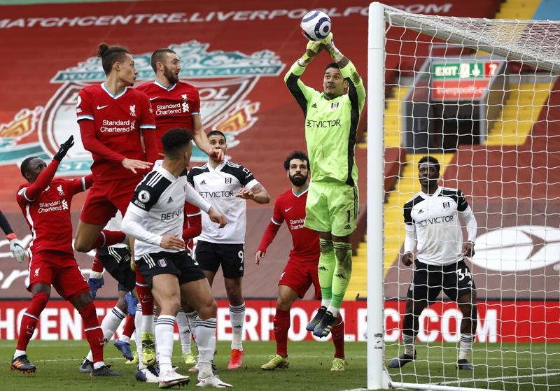 Fulham's goalkeeper Alphonse Areola punches the ball away during the English Premier League soccer match between Liverpool and Fulham at Anfield stadium in Liverpool, England on Sunday.