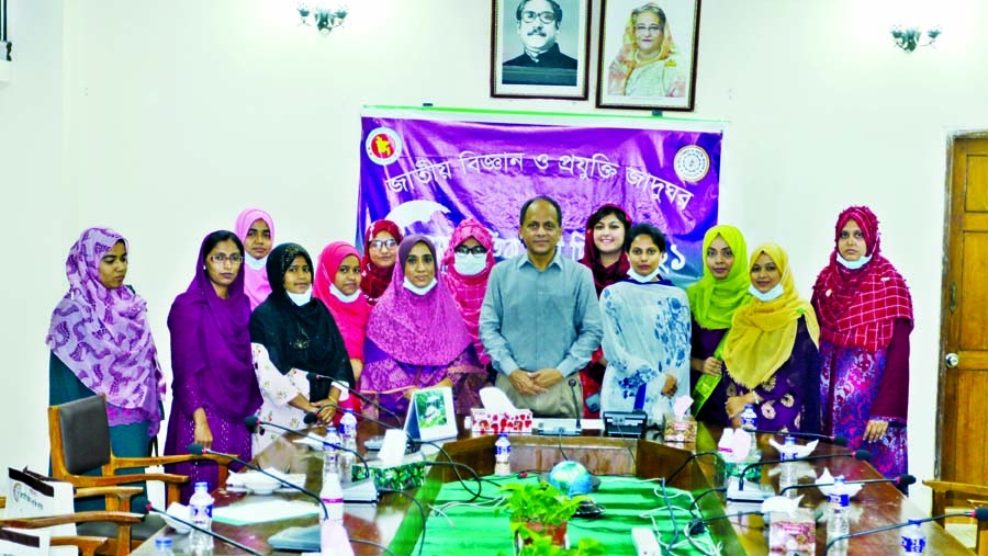 Director General of the National Science and Technology Museum Munir Chowdhury poses for a photo session with the recipients of prize at the museum in the city on Monday marking the International Women's Day.