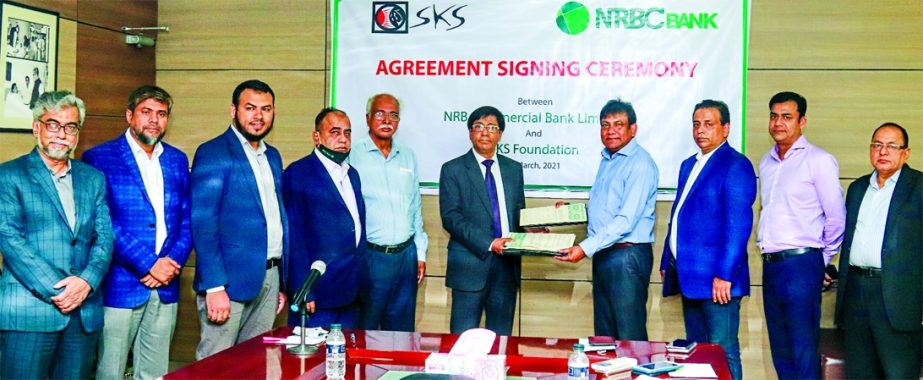 Md. Mukhter Hossain, Managing Director & CEO of NRB Commercial Bank Limited and Rasel Ahmed Liton, CEO of SKS Foundation, exchanging document after signing a MoU at the bank's head office in the city recently. Under the deal, both organizations will work