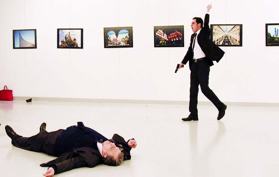 This photo shows Andrei Karlov, the Russian ambassador to Ankara, lying on the floor after being shot by Mevlut Mert Altintas (R) in an attack during a public event in Ankara.