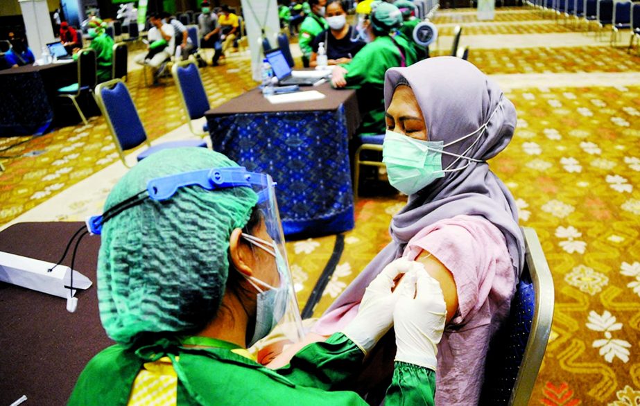 A medical worker administers the Covid-19 coronavirus vaccine during a vaccination drive targeting ride-hailing drivers and front-line hospitality workers in Nusa Dua, Indonesia's resort island of Bali.