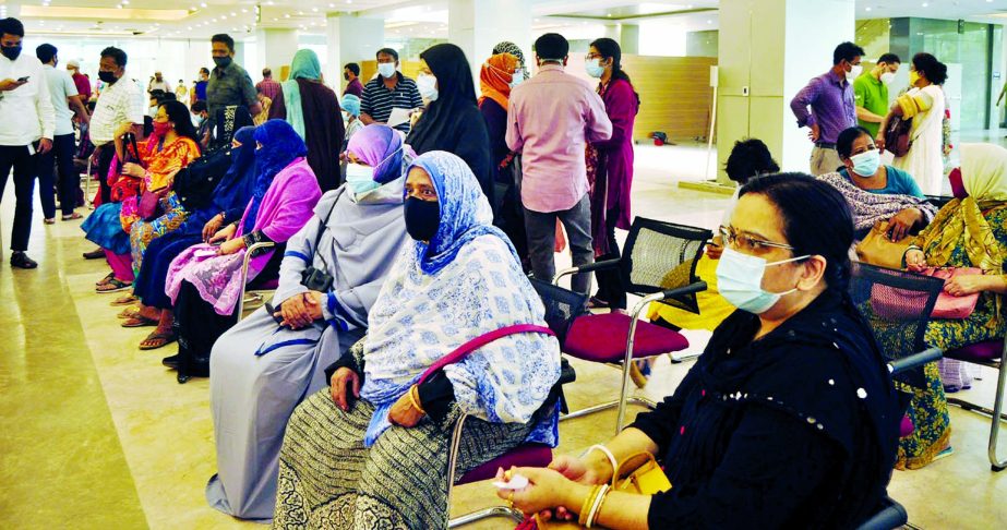 Women wait to get Covid-19 vaccine at the Bangabandhu Sheikh Mujib Medical University (BSMMU) in the capital on Thursday amid rising coronavirus infection rate in Bangladesh.