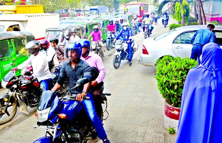 Defying traffic rules, motor cyclists are riding through footpath causing disturbance to pedestrians. This photo was taken from in front of Polytechnic College in city on Thursday.