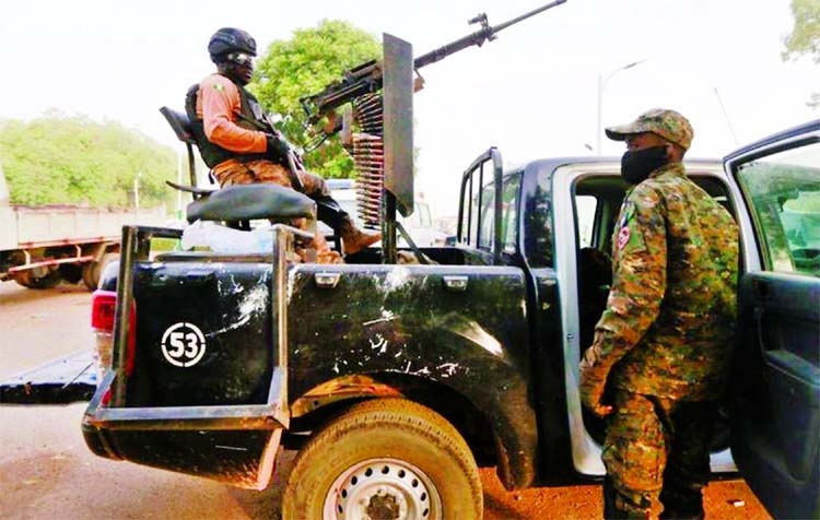 A soldier sits on one of the trucks used to bring back the girls who were kidnapped from a boarding school in the northwest Nigerian state of Zamfara, following their release in Zamfara, Nigeria.