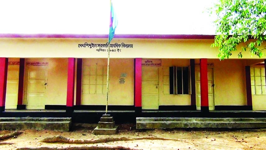 Office room of Meghshimuil Government Primary School in Brahmanbaria's Bijoynagar upazila is seen closed but the national flag is flying outside. Due to the long closure induced by pandemic situation, dumps and wastage are seen everywhere on the campus,