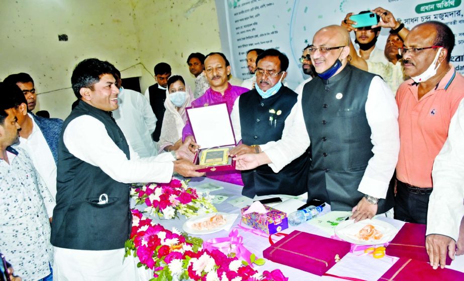 Food Minister Sadhan Chandra Majumder and State Minister for Information Dr Murad Hasan jointly hand over honorary award to 26 No Ward Councillor of Dhaka South City Corporation Hasibur Rahman Manik for his important contribution during Covid-19 pandemic